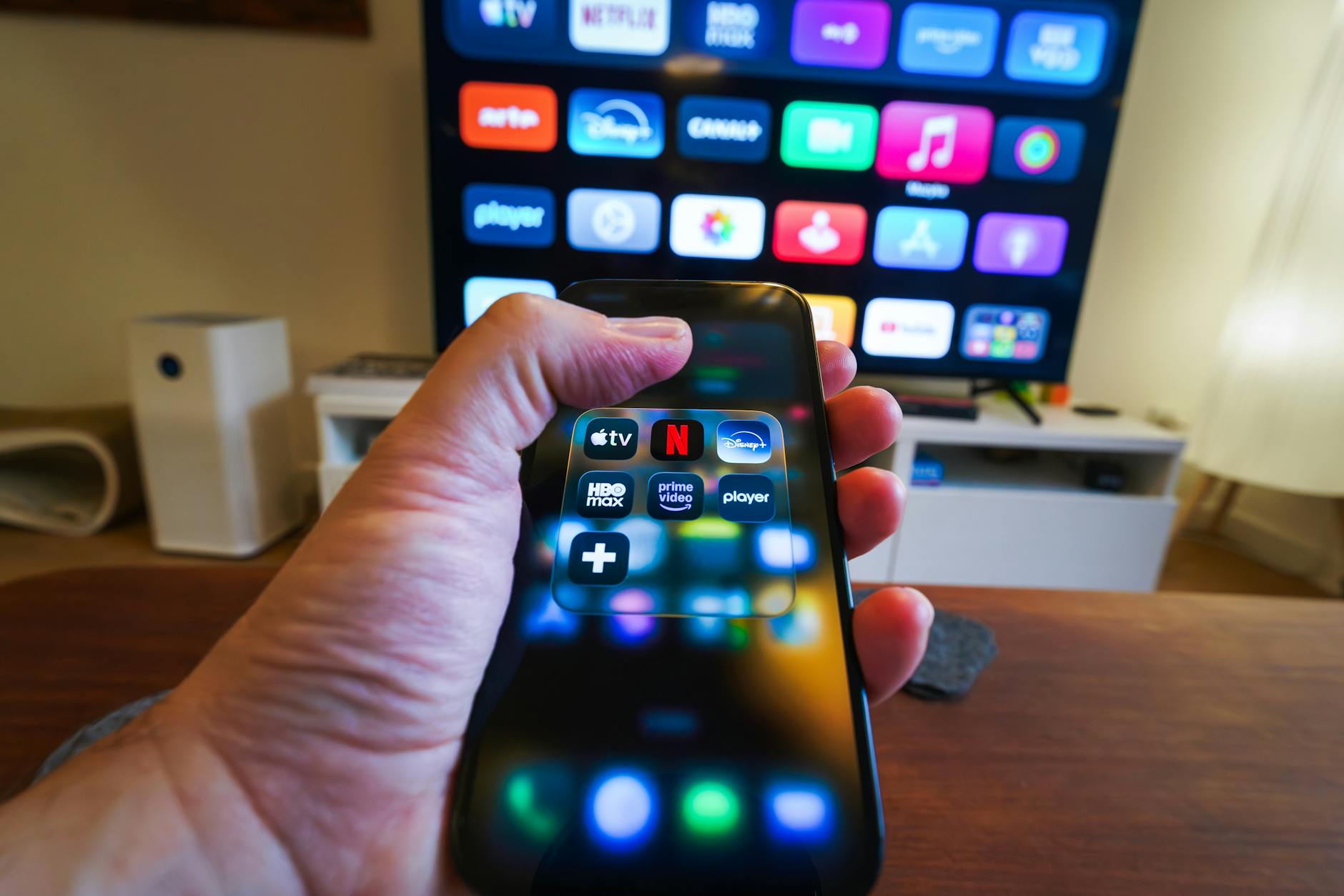 hand holding smartphone with streaming apps