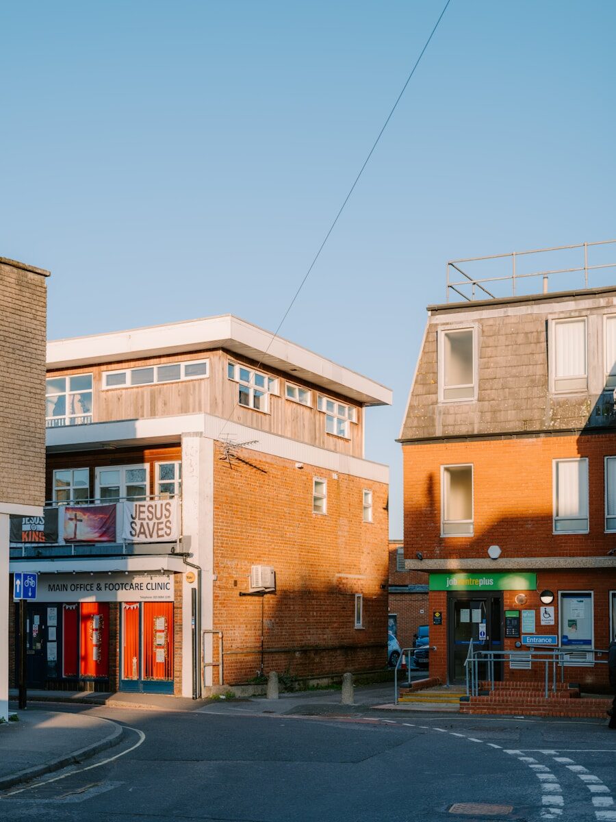 Buildings on a street corner under clear sky